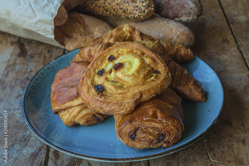 Various of french viennosieries and breads on rustic wooden background photo