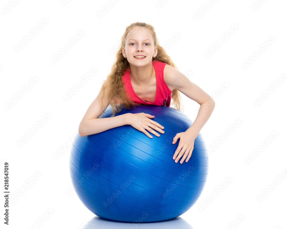 little girl doing exercises on a big ball for fitness. little girl doing exercises on a big ball for fitness.