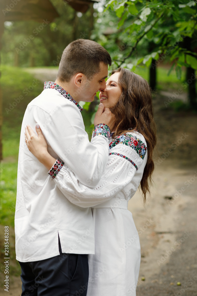 Beautiful bride and groom in the ukrainian style are standing w Beautiful bride and groom in the ukrainian style are standing w