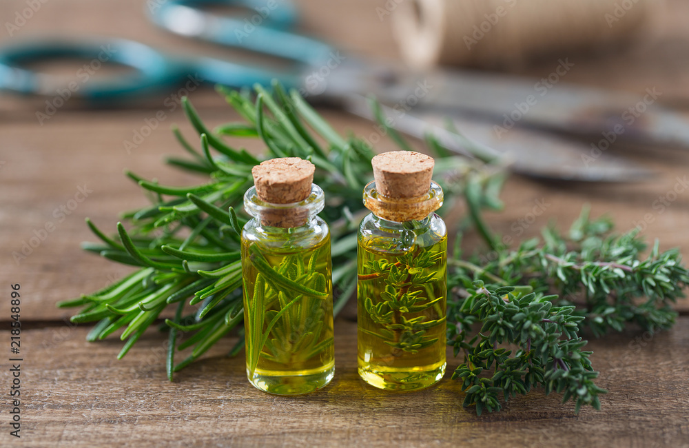olive oil with herbs on wooden surface olive oil with herbs on wooden surface