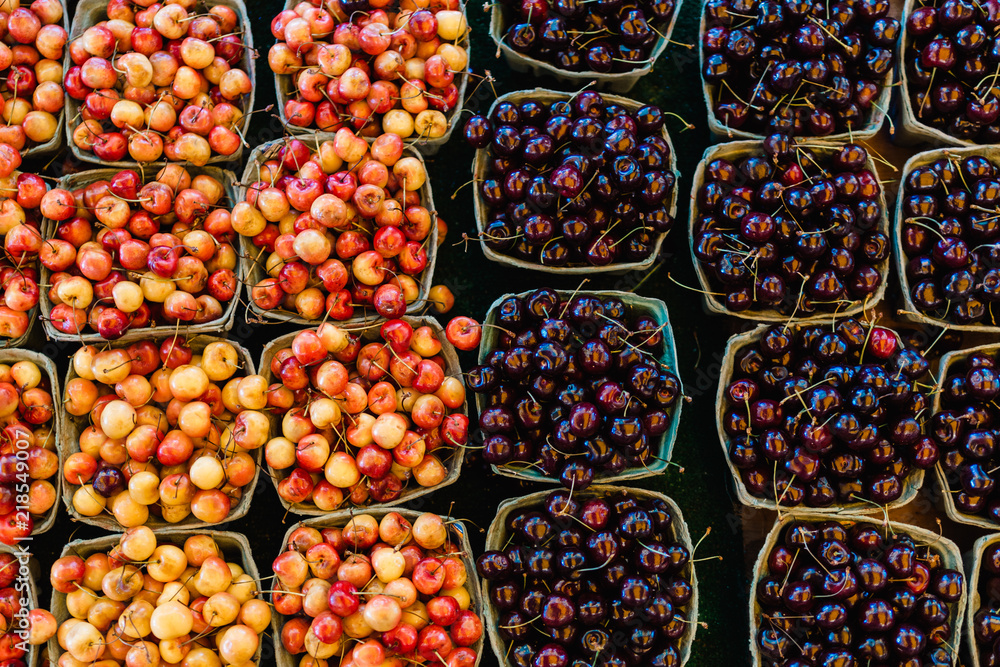 Top View of Fresh Royal Ann and Sour Cherries at Farmer's Market in Baskets Top View of Fresh Royal Ann and Sour Cherries at Farmer's Market in Baskets