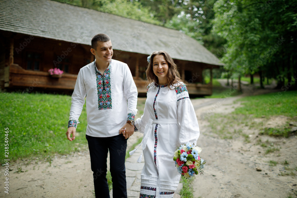  Beautiful bride and groom in the ukrainian style are standing w