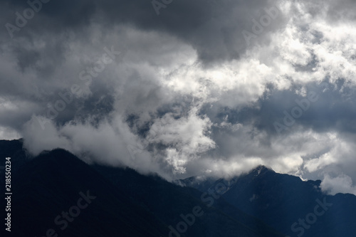 Sun rays peak through dramatic clouds over St Mary Lake in Kimberley, Canada