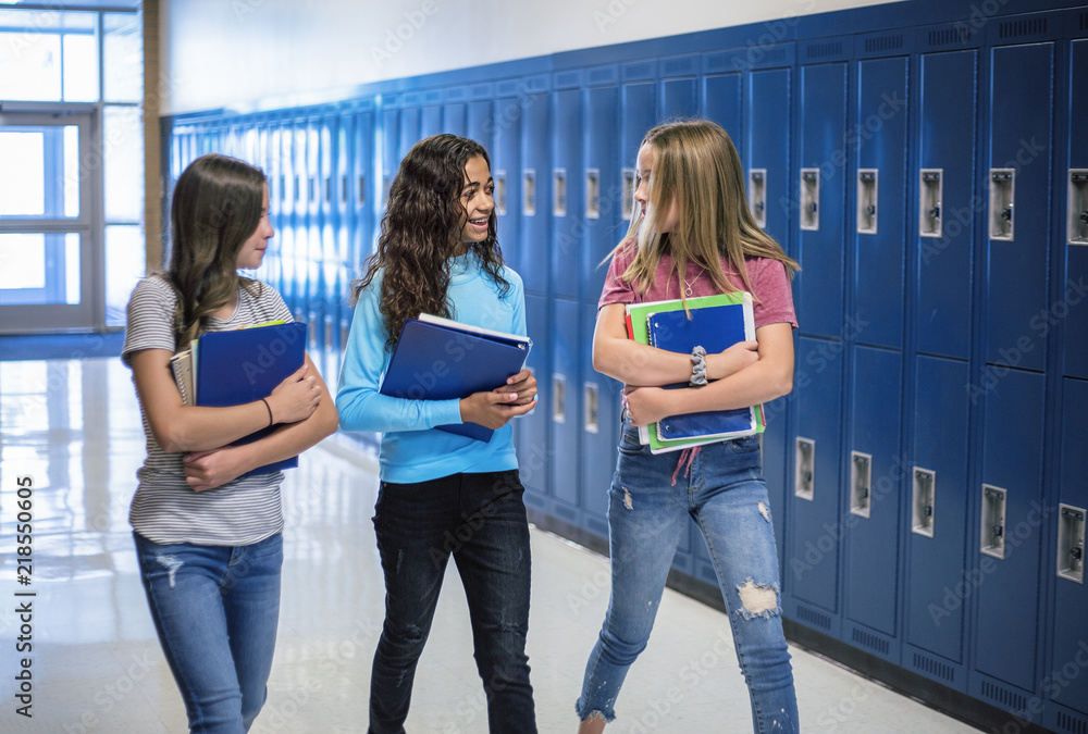 Candid Photo Of Three Junior High School Students Talking Together In A 
