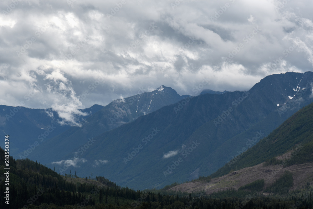 Heavy rain moves across a dramatic valley in the Canadian wilderness