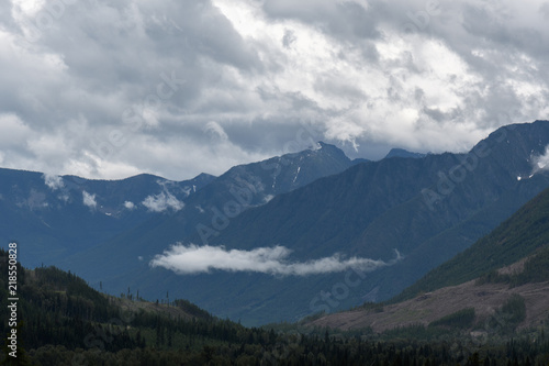 Fototapeta Naklejka Na Ścianę i Meble -  Heavy rain moves across a dramatic valley in the Canadian wilderness