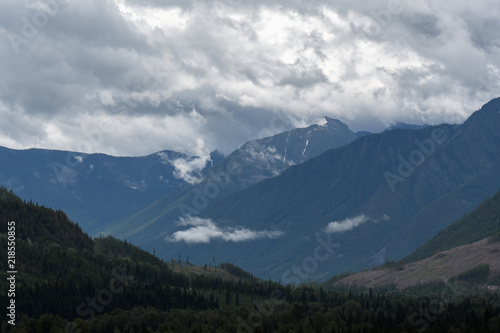 Heavy rain moves across a dramatic valley in the Canadian wilderness © Tabor Chichakly