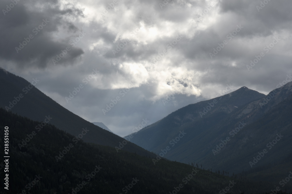Sun rays peak through dramatic clouds over St Mary Lake in Kimberley, Canada Sun rays peak through dramatic clouds over St Mary Lake in Kimberley, Canada