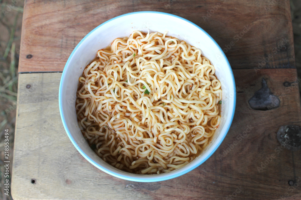 instant noodles in blue bowl on the wooden background. instant noodles in blue bowl on the wooden background.