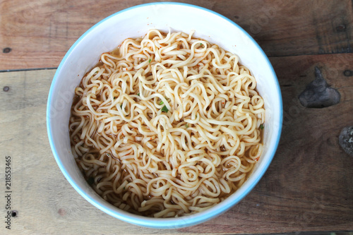instant noodles  in blue bowl on the wooden background.