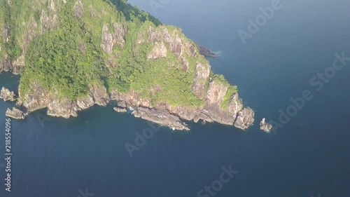 Aerial drone view of a large, uninhabited limestone island jutting up out of a tropical ocean (Mergui Archipelago, Myanmar) photo