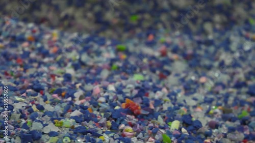 Raw material for the production of rubber toys. The material resembles crushed rubber and plastic. Closeup and panning
