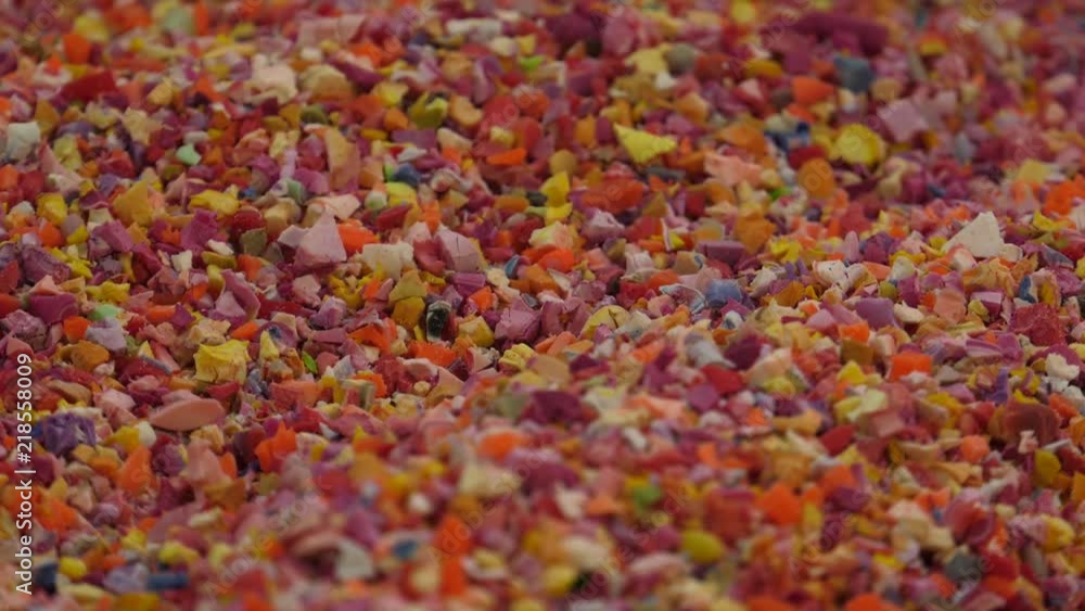 Raw material for the production of rubber toys. The material resembles crushed rubber and plastic. Closeup and panning Raw material for the production of rubber toys. The material resembles crushed rubber and plastic. Closeup and panning