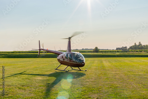 tourist helicopter ride taking off from field photo