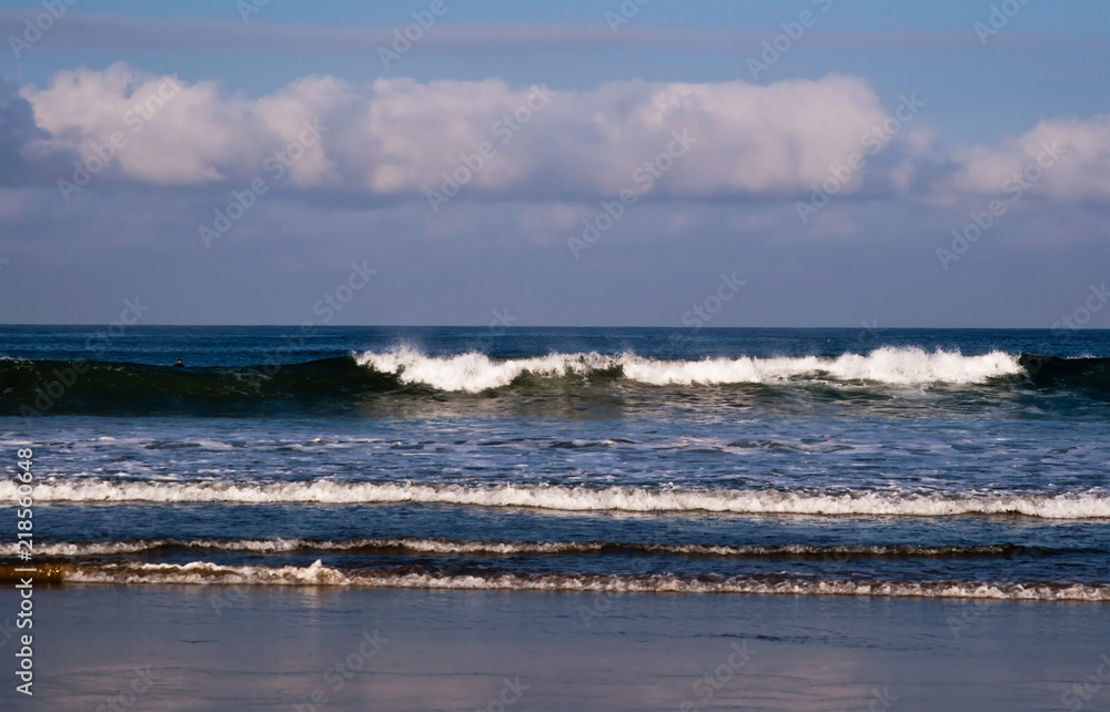 Waves crashing along the shore in southern California, USA from the Pacific ocean on a beautiful morning in summer Waves crashing along the shore in southern California, USA from the Pacific ocean on a beautiful morning in summer