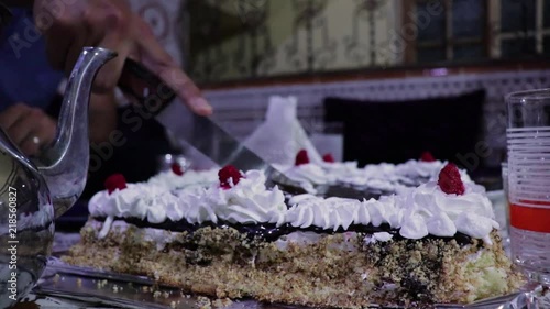 Big Happy Birthday Cake with chocolate cutted in pieces photo