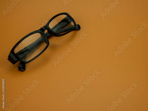 eyeglasses on color background