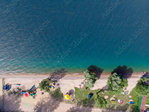 Fototapeta Naklejka Na Ścianę i Meble -  aerial view of beach with white sand and big lake with green water