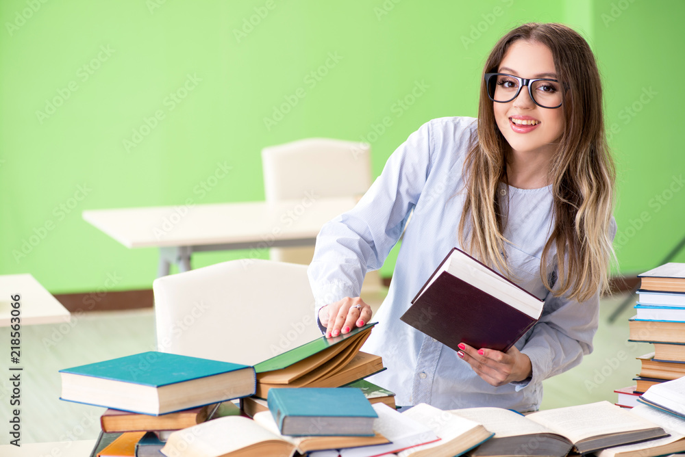 Young female student preparing for exams with many books Young female student preparing for exams with many books