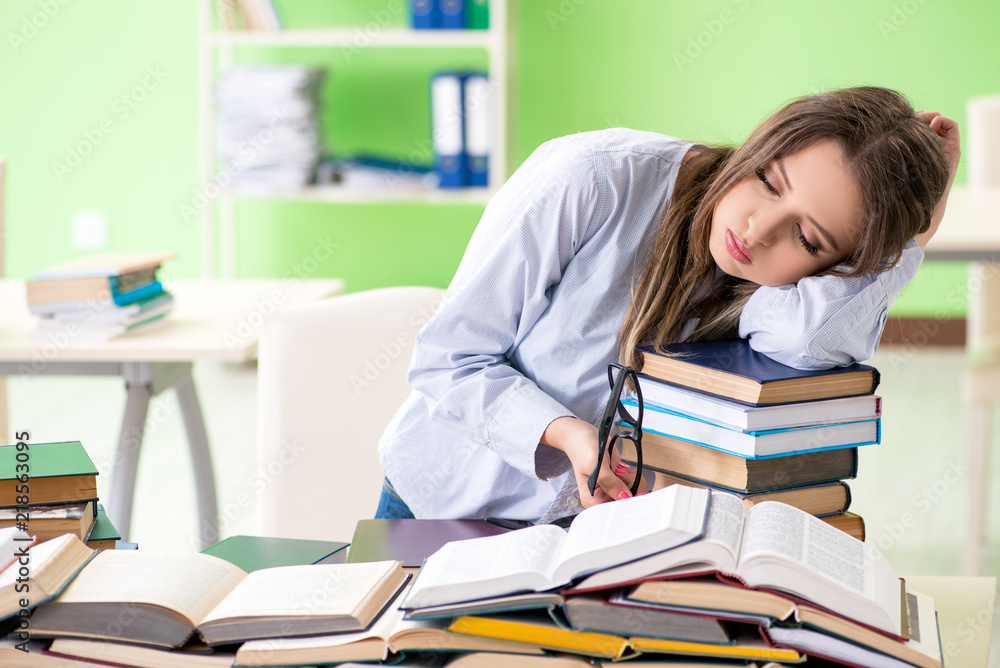 Young female student preparing for exams with many books Young female student preparing for exams with many books