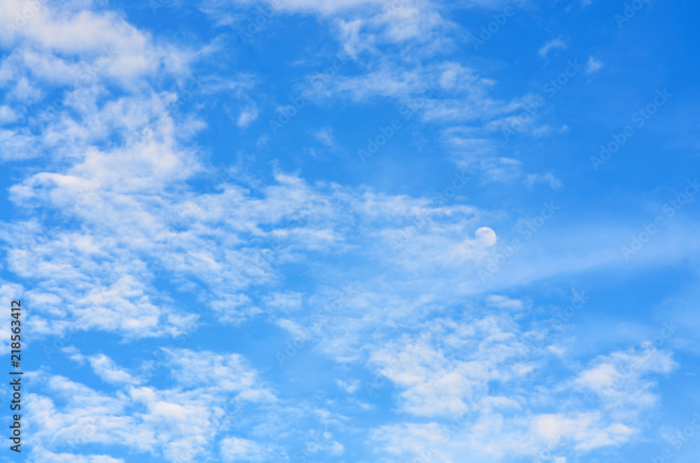 Nature background. White clouds and moon over blue sky. Nature background. White clouds and moon over blue sky.