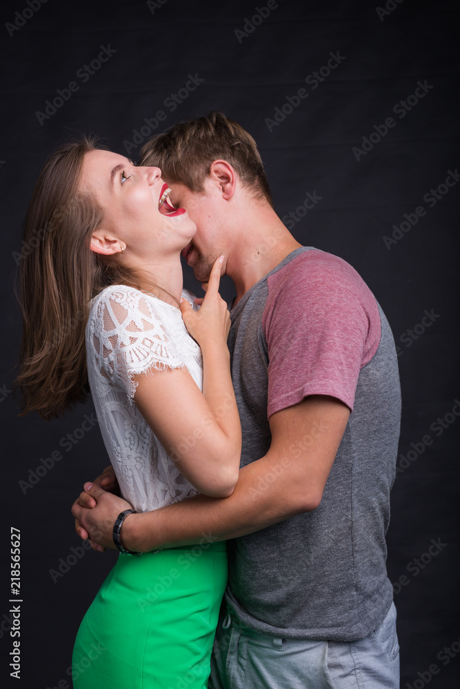 Passionate young people in love on black background Passionate young people in love on black background