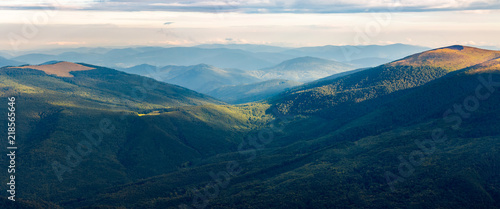 beautiful panorama of mountain range in morning light. alpine meadows with weathered grass.