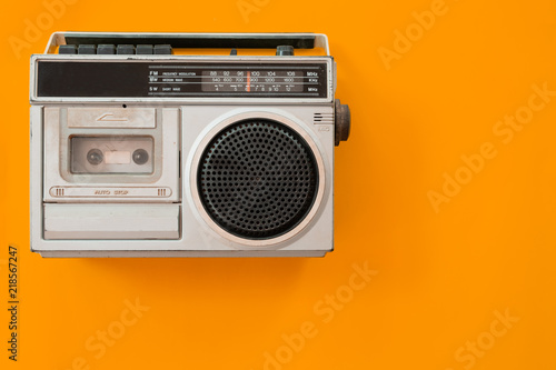 vintage radio and cassette player on colour background, flat lay, top view. retro technology photo