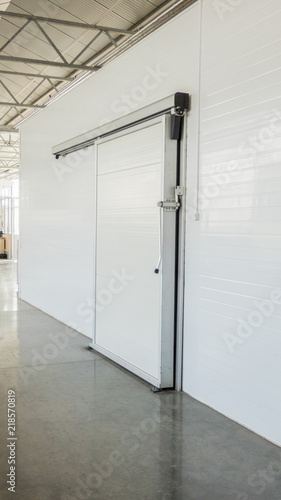 large freezer storage in the factory. closed door from warehouse