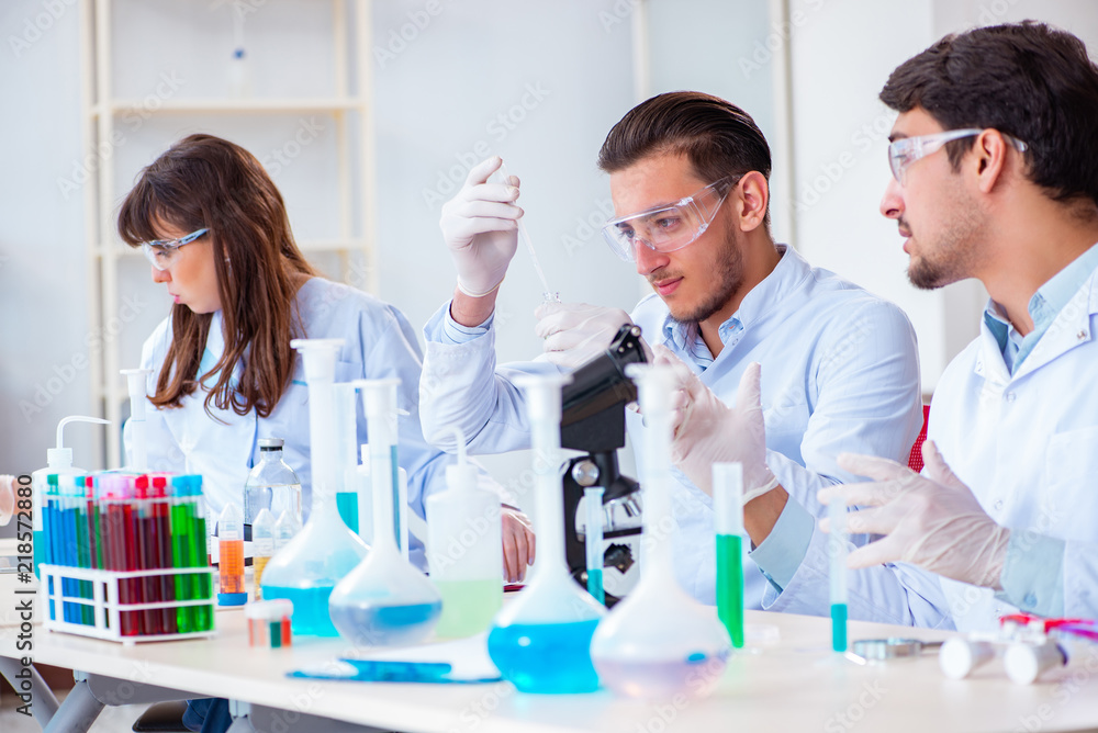 Team of chemists working in the lab Team of chemists working in the lab