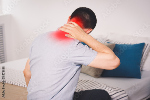 Neck pain, man suffering from backache at home