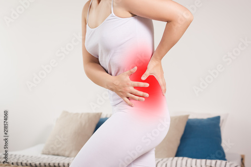 Stomach ache, woman with abdominal pain suffering at home photo