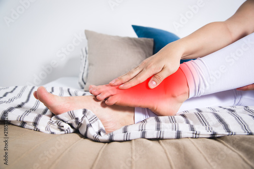 Woman's leg hurts, pain in the foot, massage of female feet