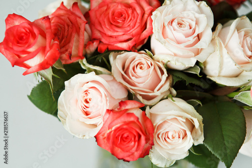 a bouquet of cream and orange roses on a white background