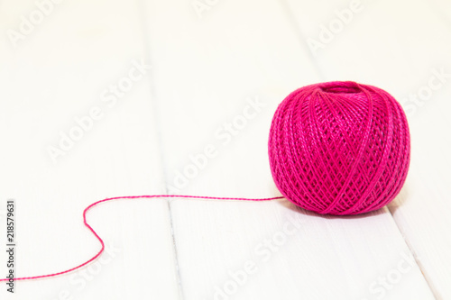 Pink thread for knitting in a roll