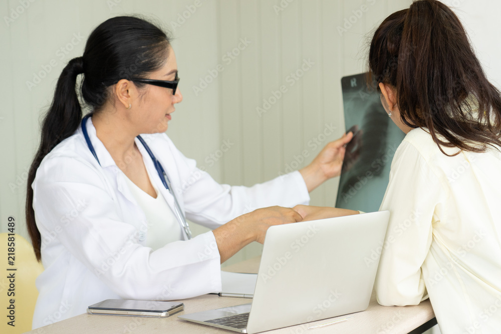 Female doctor talking to patient.Doctor and patient discussing something while sitting at the table . Medicine and health care concept. Doctor and patient Female doctor talking to patient.Doctor and patient discussing something while sitting at the table . Medicine and health care concept. Doctor and patient