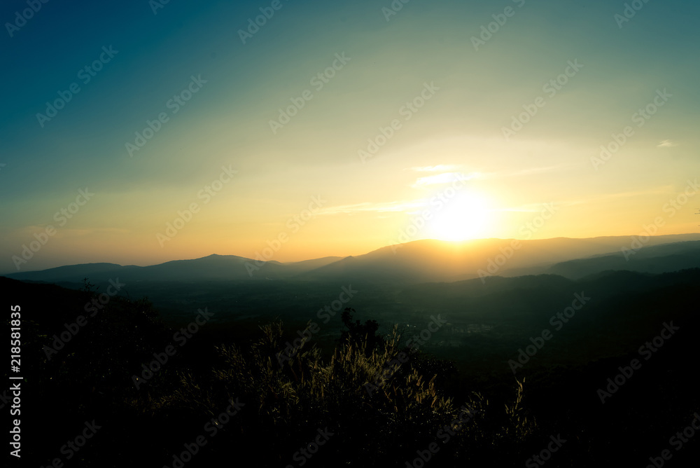Fototapeta premium Scenic view of sunrise mountains at northeast Thailand, Mountain range for climbing in mountain trails. the landscape of mountain which including of copy-space for texting. 