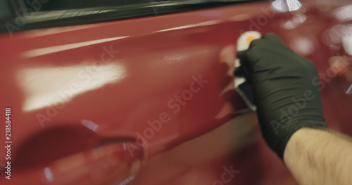 closeup applying ceramic coating on the red car © GCapture