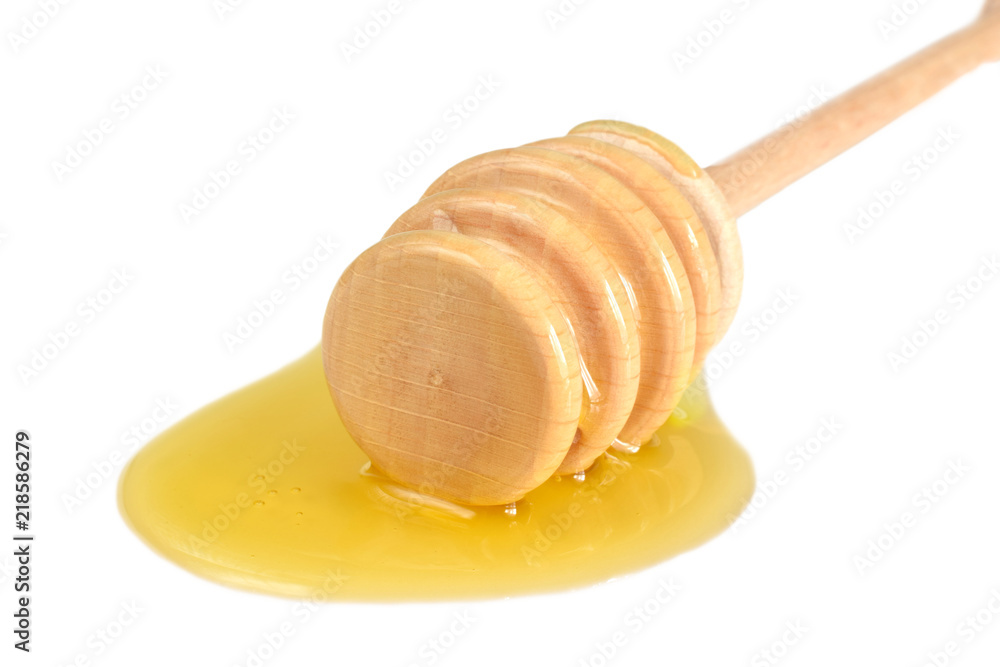 Honey on honeyspoon macro isolated on white Honey on honeyspoon macro isolated on white