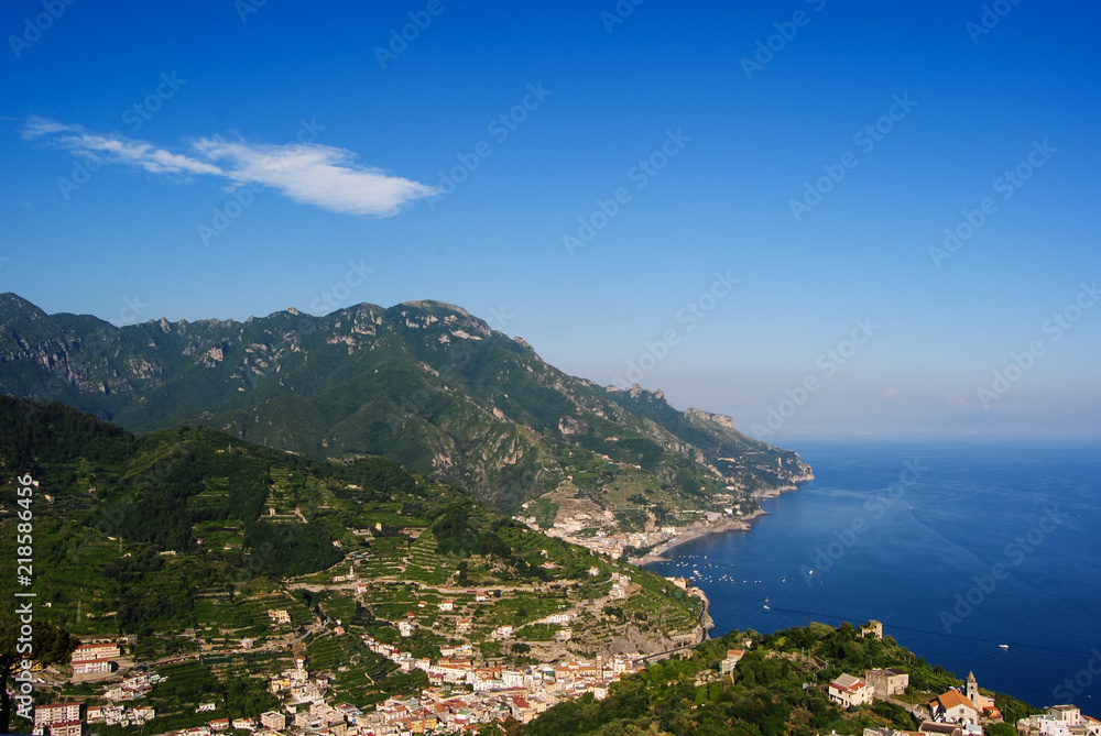 Small Italian villages in the covered with greenery mountains of Amalfi coast. Shot from Ravello on a sunny day  