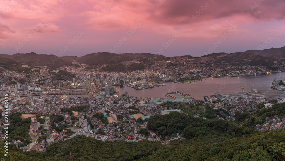 Panorama image of the city Nagasaki, at sunset, cloudy sky.