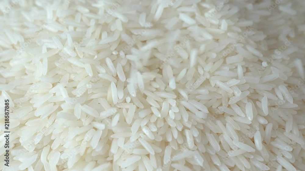 Slow motion of close up falling raw rice / uncook rice. (High speed video) Slow motion of close up falling raw rice / uncook rice. (High speed video)