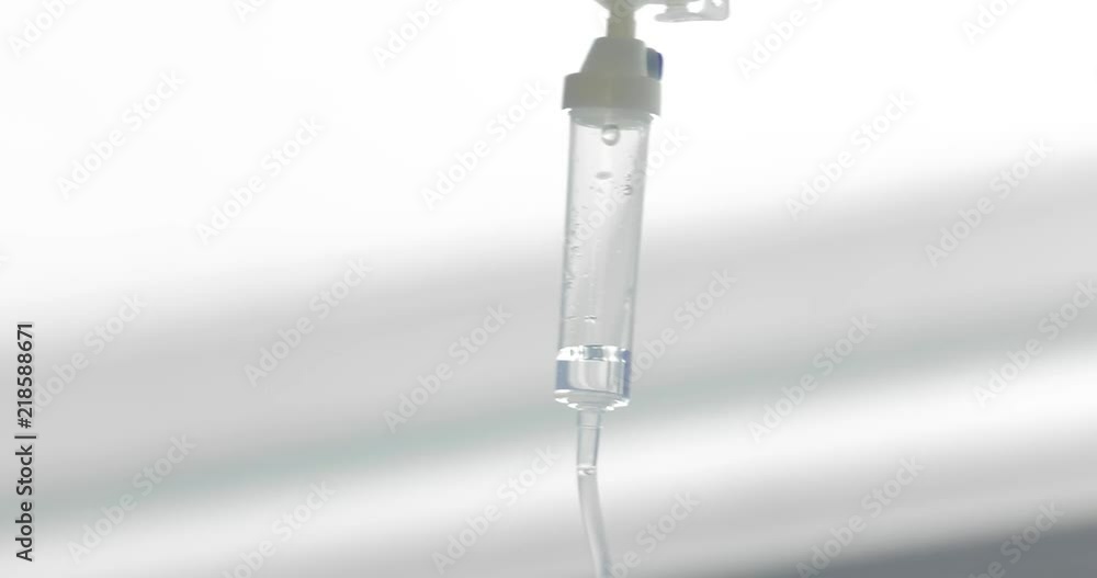 A glucose drip is suspended over the hospital bed. Drip drop after drop. Panning camera, Pan, Closeup A glucose drip is suspended over the hospital bed. Drip drop after drop. Panning camera, Pan, Closeup