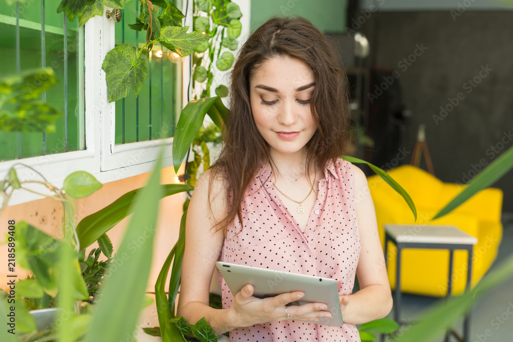 people, interior and education concept - young woman with a tablet in stylish green apartment people, interior and education concept - young woman with a tablet in stylish green apartment