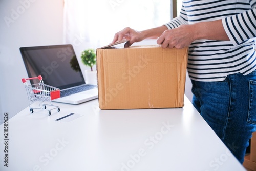 woman preparing package delivery box at home online order shopping.