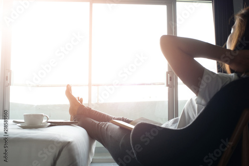Happy woman relaxing comfortably at home.