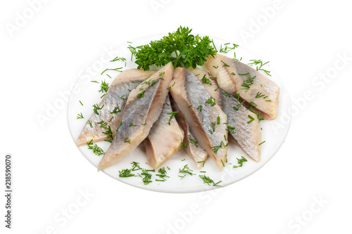 Herring fillets sliced with herbs on a plate isolated on white background