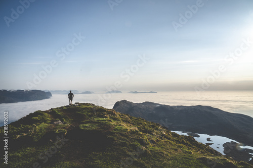 Guy running on top of a mountain.