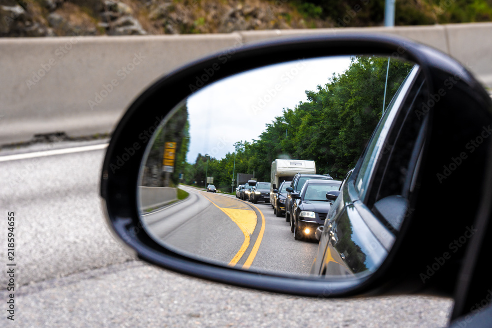 Traffic jam seen through side mirror of car