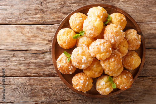 Chouquettes French Cream Puffs dessert is decorated with pearl sugar and mint closeup. Horizontal top view